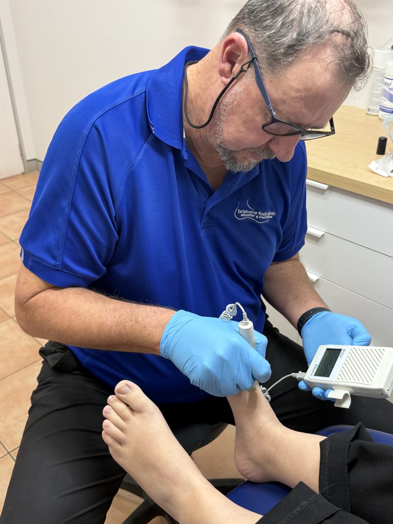https://brisbanefootclinic.com.au/wp-content/uploads/2026/06/Close-up-of-Wayne-with-Doppler-768x1024.jpeg